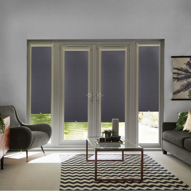 Acacia Black Perfect Fit Roller blinds on four French Doors in a modern living room. The blinds are black and contrast against a sofa, armchair and coffee table.