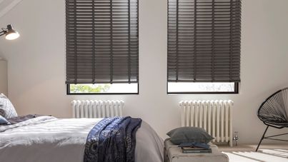 Large bedroom with contrasting dark wooden blinds