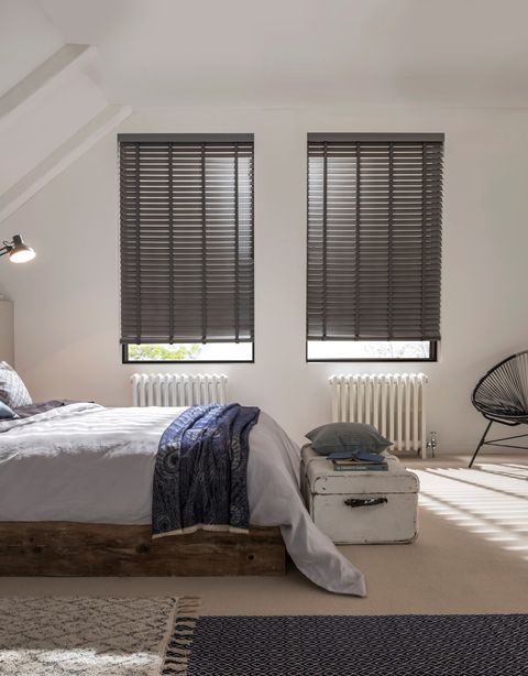 Large bedroom with contrasting dark wooden blinds