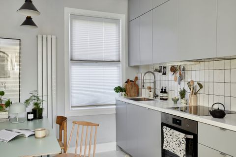 Pleated Grenoble cream blinds at kitchen window