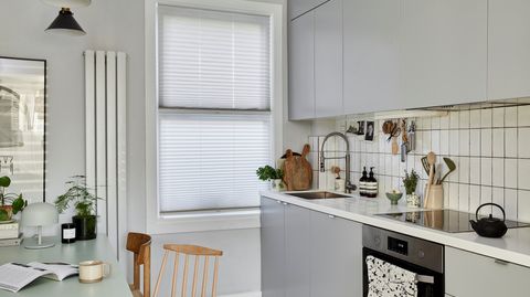 Pleated Grenoble cream blinds fitted to a kitchen window