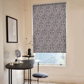 The Matchsticks Mono blind hangs in the recess in a large window. The printed Roller blind has been adjusted to allow a small amount of light into the room.