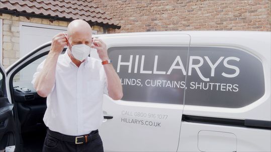 Hillarys advisor wearing mask outside van