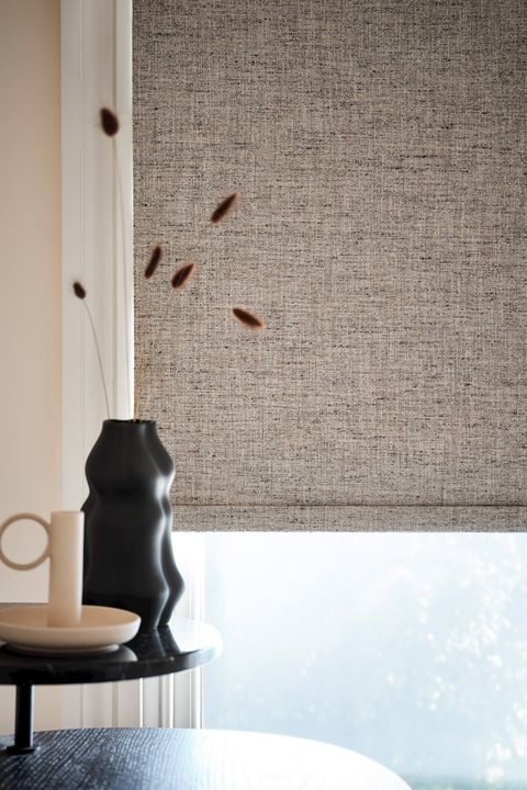 A grey-texture blind with monochrome furnishings