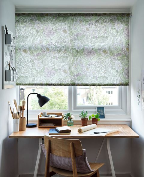 Study space with a green, floral blind and wooden accompaniments