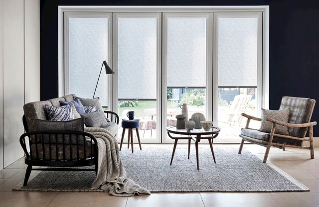 Conscious Soot Blackout perfect fit Roller blinds displayed on external windows allowing light into the room beneath them 