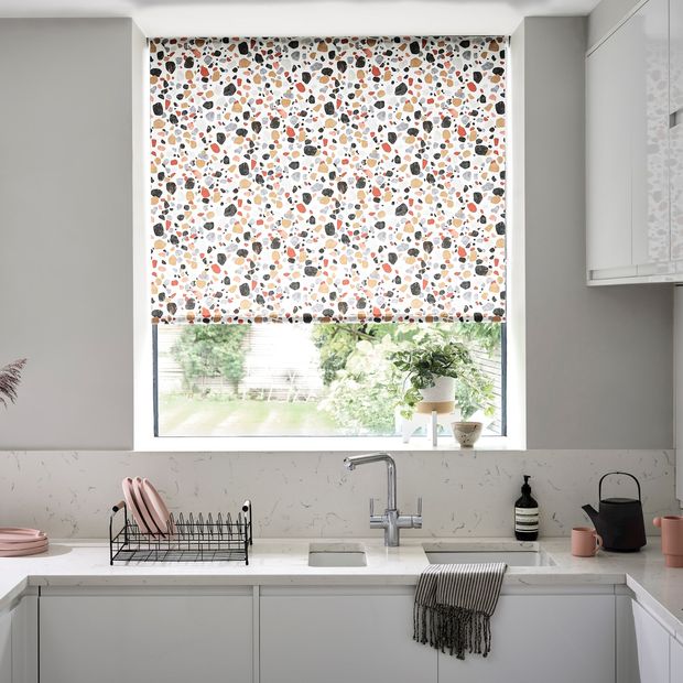 Lucca Brick Roller Blind fitted to a window above a sink in a white decorated kitchen