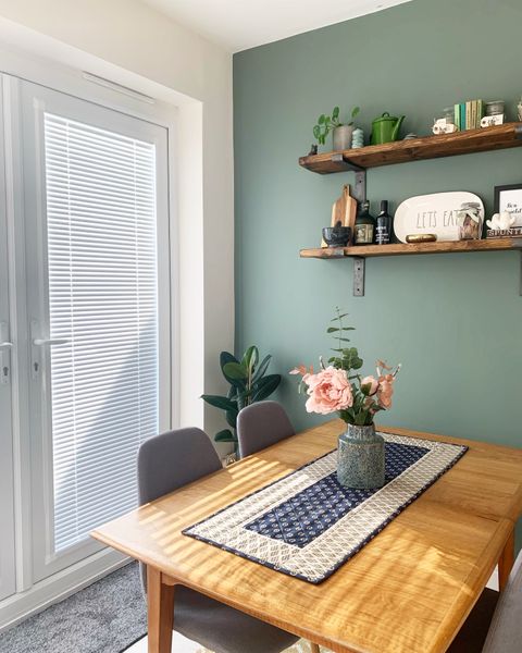 White, perfect fit blinds in a muted green kitchen