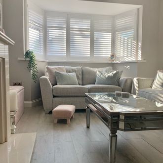 White Shutters in a neutral living room with light pink accents