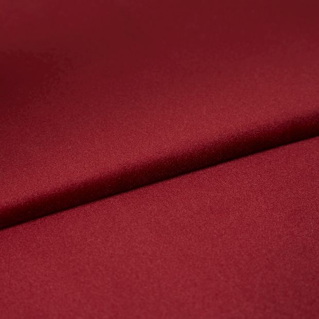 Folded red fabric of Darcia Rouge Roman Blind