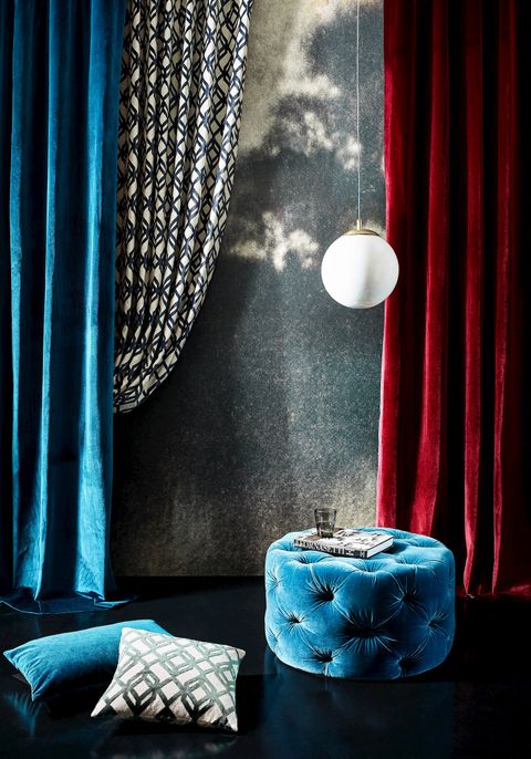 Velvet teal and rouge curtains in a dark living room with teal accents