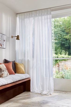 Orford White Voile curtains dressing modern french doors leading to a garden