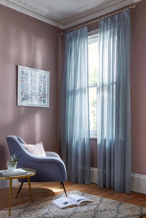 Echo sky voile curtains in sitting room sash window with purple armchair