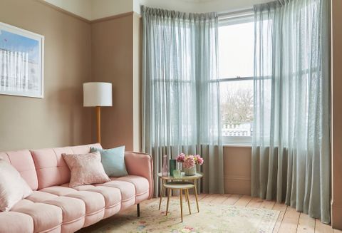 Serenity seaglass voile curtains in 3-sided sash bay window with light pink sofa and pastel accessories