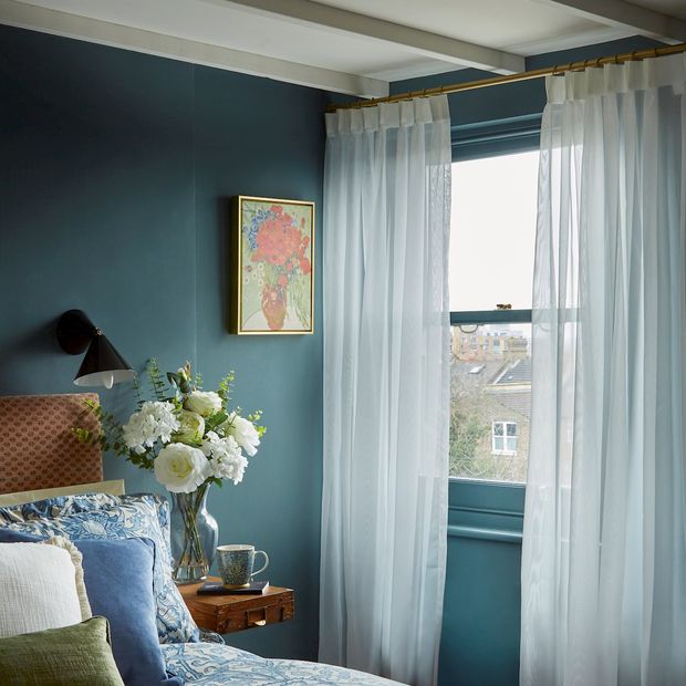 Clarity ivory voile curtains in bedroom window with dark wall colour