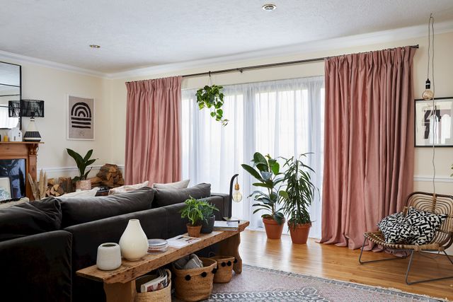 Astro ivory voile curtains layered with bailey taffy curtains across wide patio doors in living room with house plants and greenery