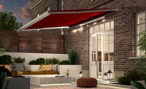 Verona Rouge awning and lightbar outside in the garden at night 