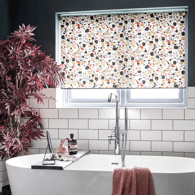 Lucca Brick Roller blind in a bathroom window with chrome accessories 