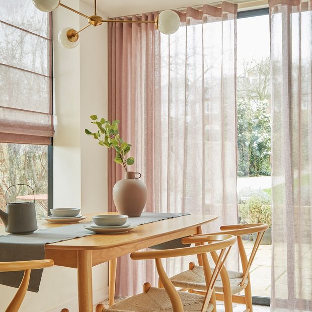 serenity powder pink voile curtains full height in a dining room with a light wooden table and grey crockery