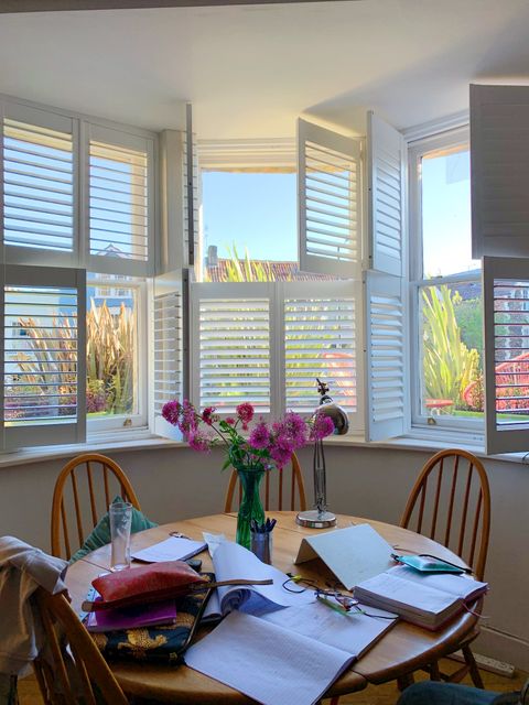 White tier on tier shutters in bay window dining room