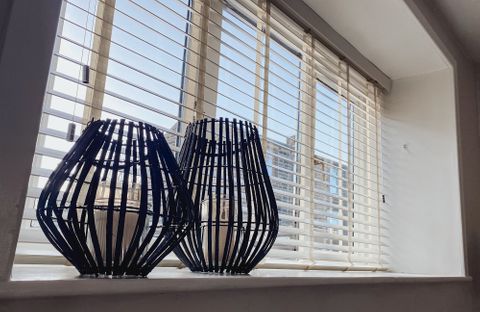 White Venetian Blind opened allowing light into the room