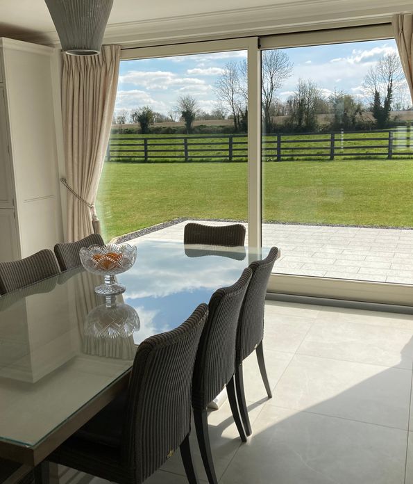 Cream pinch pleat curtains in a modern dining room