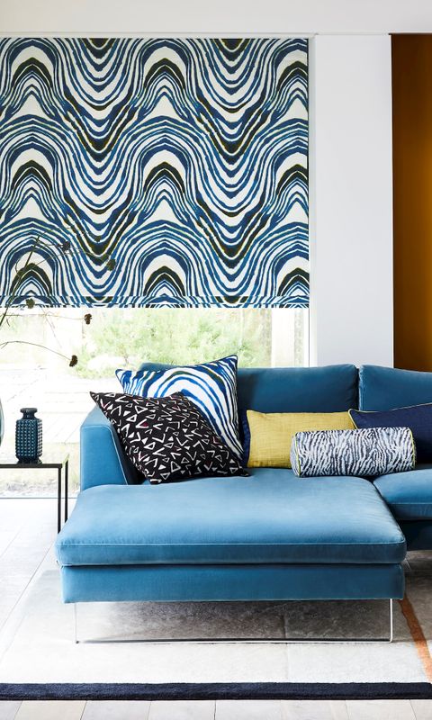 Blue blinds in a living room with a sofa