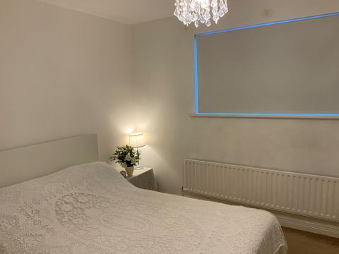 Customer Janis Philip-Clark's white bedroom Roller blind with white bed