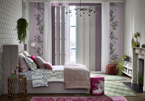 Light purple, tracked, solid shutters in a colourful bedroom