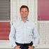 George Clarke stood in front of different venetian and vertical blinds