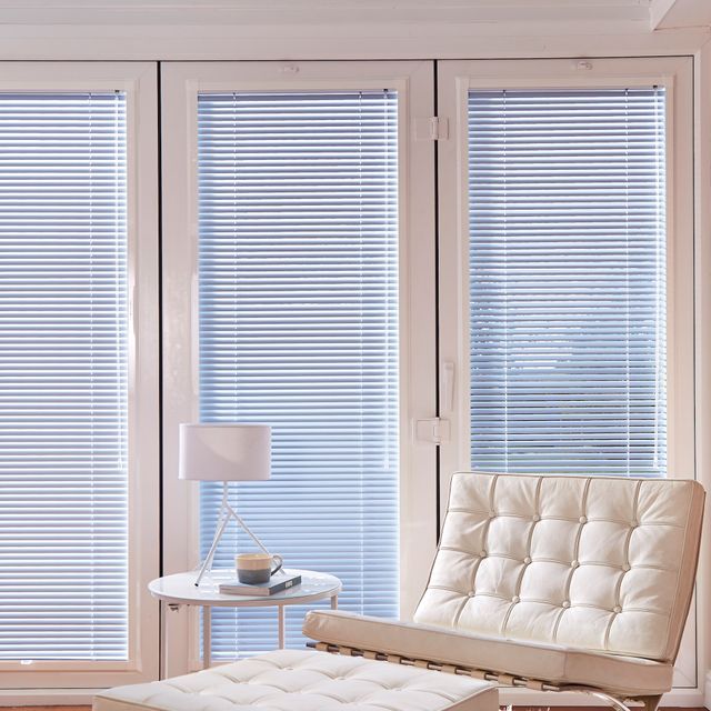 Blue perfect fit pleated blinds in a modern living space