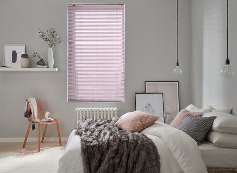 muted pink metal venetian blinds in a cosy, neutral bedroom