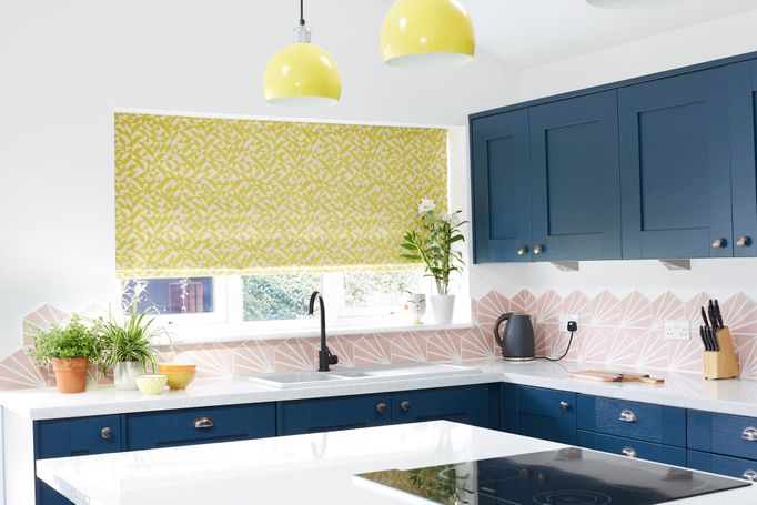Terrazzo Sulphur roman blind fitted to a window in a blue and white decorated kitchen