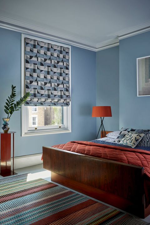 Renzo Navy Roller blind on  a window in a blue decorated bedroom