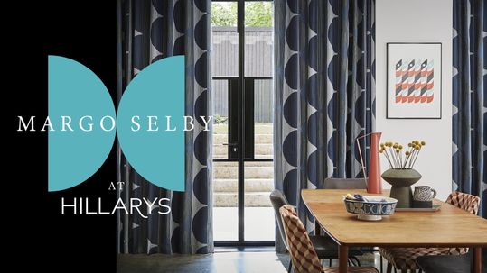Margo Selby logo in front of a dining room with curtains patterned with circles