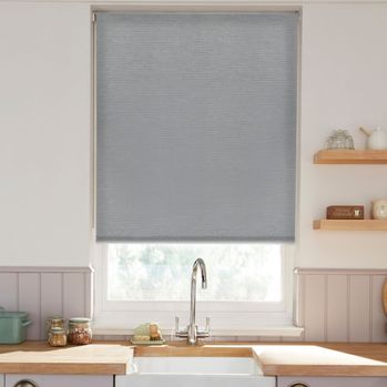silver coloured roller blind fitted to a window above a sink in a kitchen