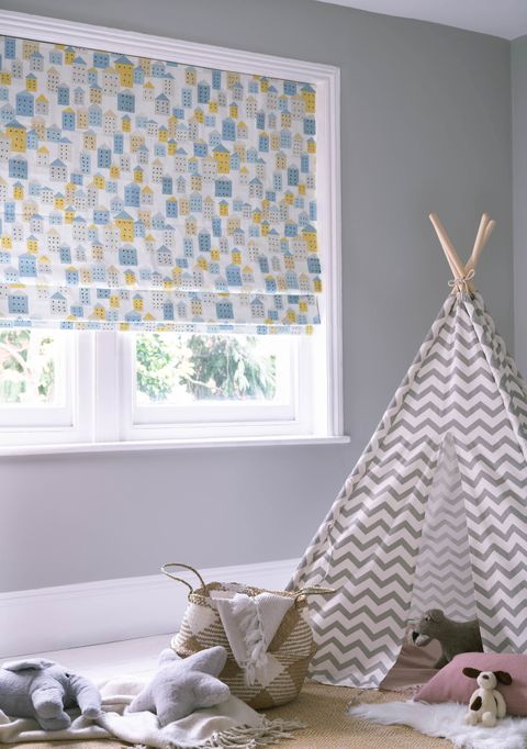 Roman blinds in a children's room. A children teepee on the right side and toys on the floor. 