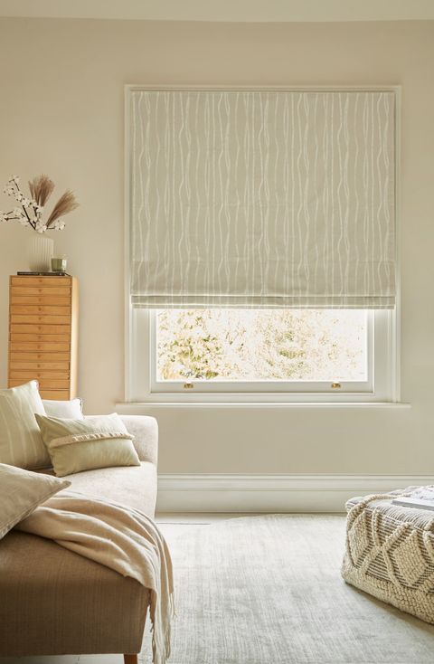 Flow Sesame roman blind fitted to a rectangular window in a living room  decorated in neutral colours