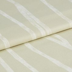 Yellow and white striped pattern Flow Sesame on folded fabric