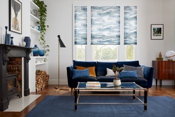 House Beautiful Ripple Blue Pleated blinds in a living room with a navy sofa