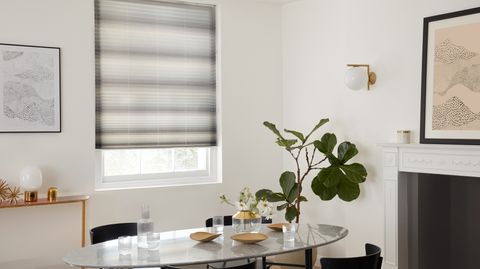 grey pleated blinds fitted to a window in a white decorated dining room