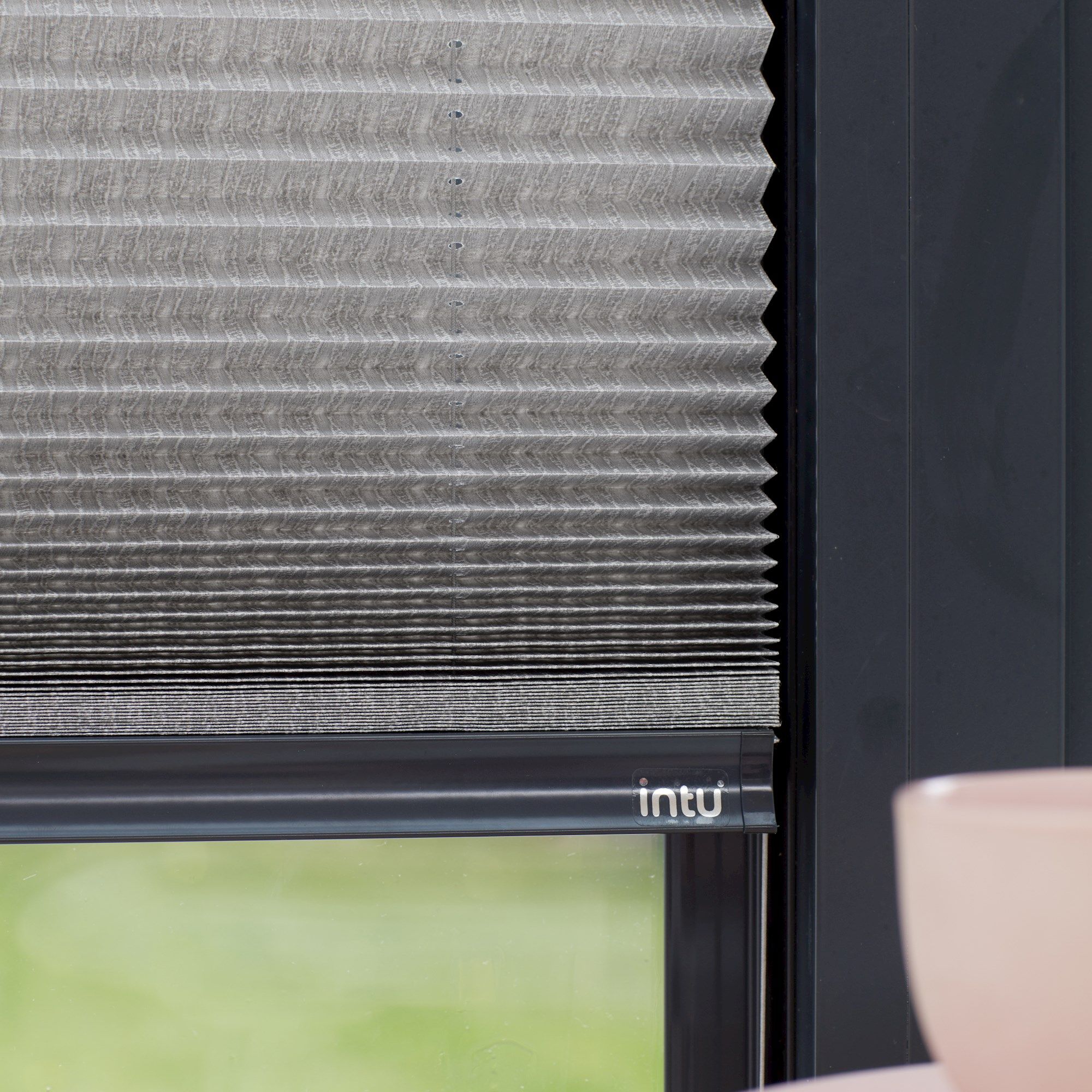 Close up of grey Micro Pleat Pleated blinds dressed on bi-fold doors.