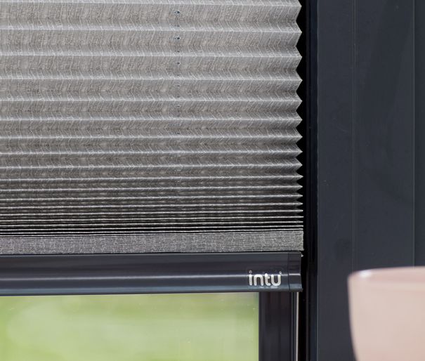 Close up of grey Micro Pleat Pleated blinds dressed on bi-fold doors.