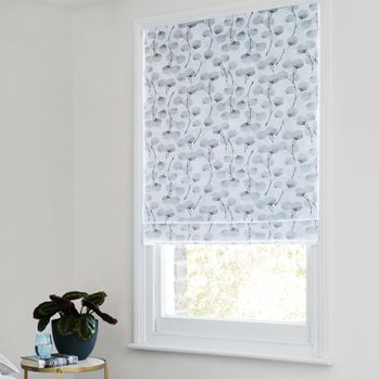 White and grey floral patterned honesty frost roman blind in light bedroom sash window