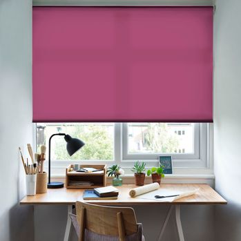 Reber Fuchsia Roller Blind with a desk in front of the window and a lamp on the table and office stationary