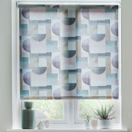 Savoy Peacock roller blinds at a window with a window shelf with potted plants on it