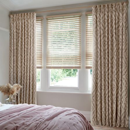 Alto Cinnamon Curtains and Wood Venetians in Limed White in a bedroom
