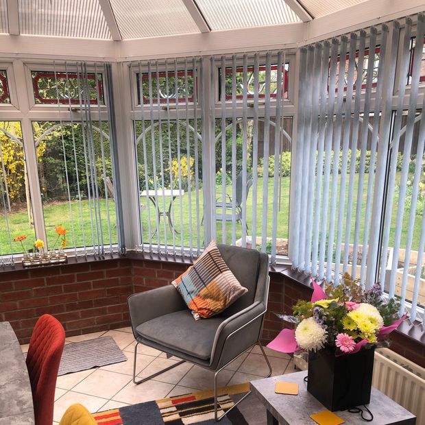 Malin Light Grey vertical blind in colourful conservatory