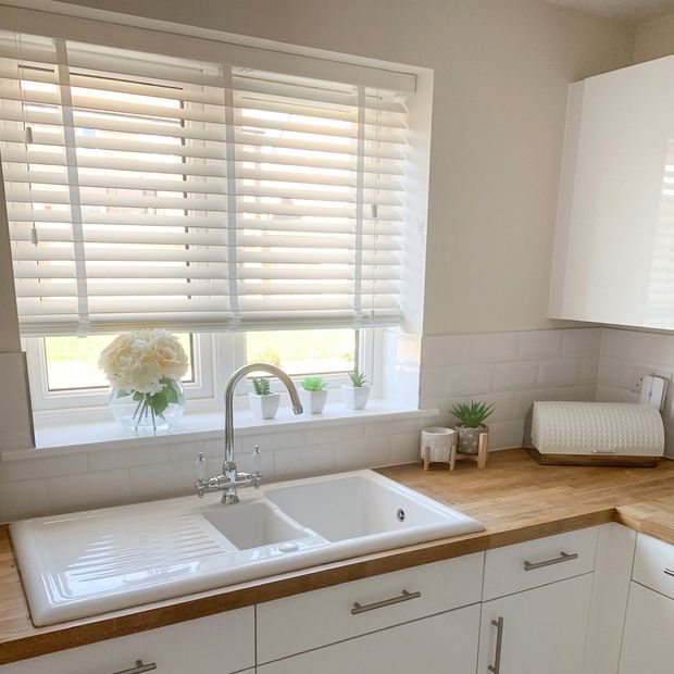 Illusions soft ivory faux wooden blinds with white tape in kitchen