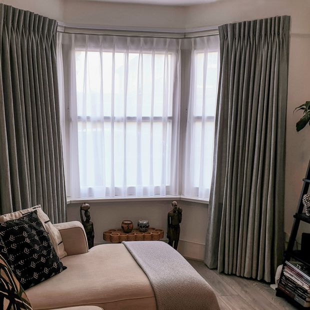 cley donkey curtains paired with white voiles in a living room bay window